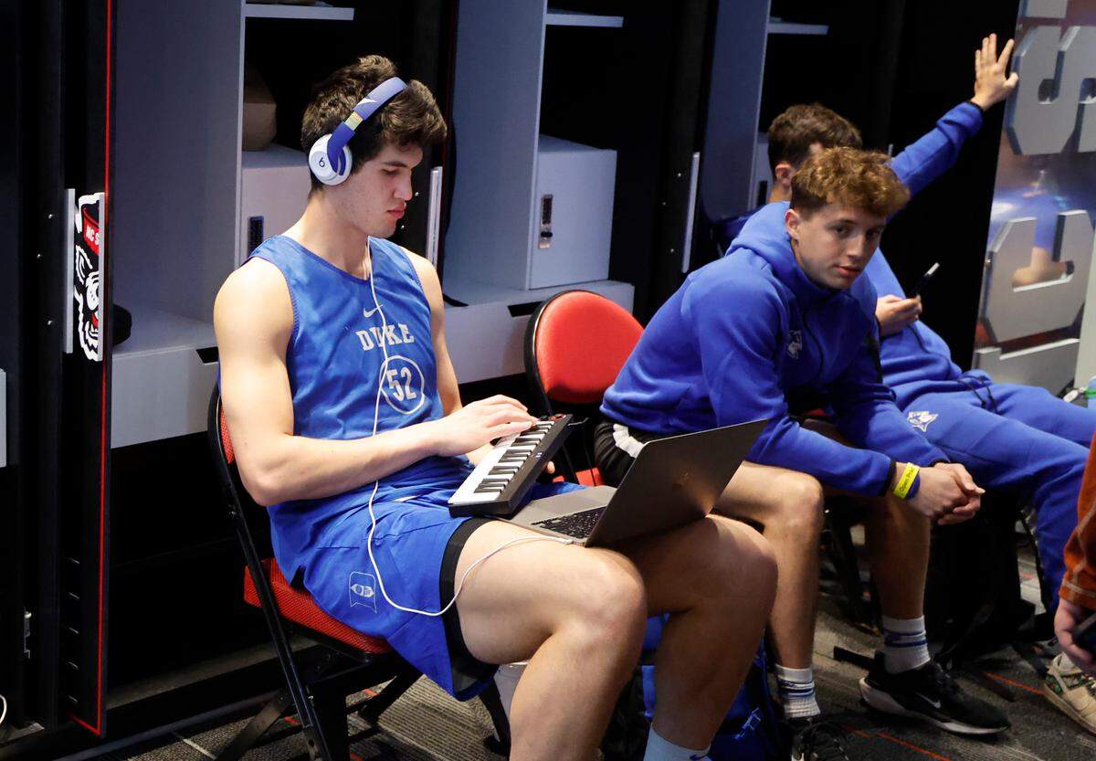Duke’s Stanley Borden (52) plays his keyboard in the locker room before the Blue Devils’ open practice at the Lenovo Center in Raleigh, N.C., Thursday, March 20, 2025. The Blue Devils will face Mount St. Mary’s in the first round of the NCAA Tournament Friday.