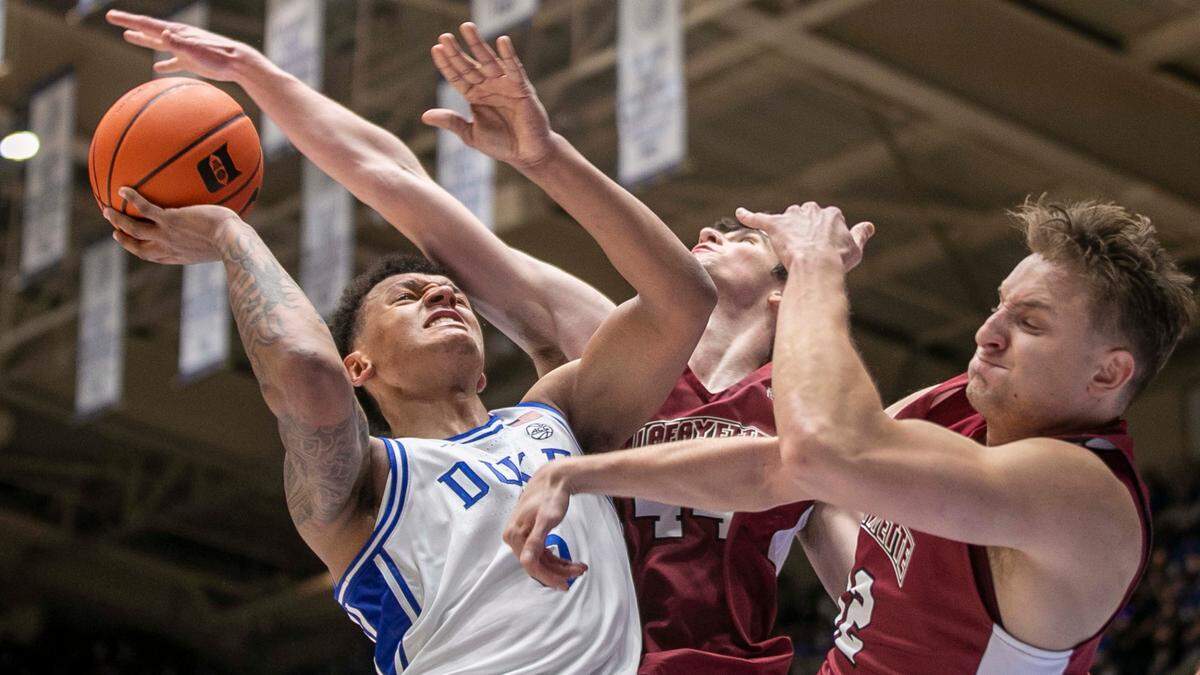 Duke’s Paolo Banchero (5) drives to the basket against Lafayette’s Chris Rubayo (44) and Tomas Verbinskis (12) during the first half on Friday, November 19, 2021 at Cameron Indoor Stadium in Durham, N.C.