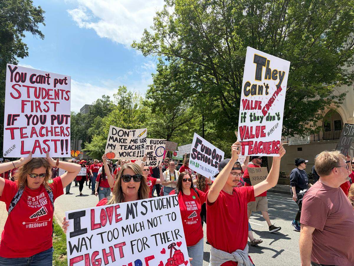 Protesters march in downtown Raleigh during a May Day event to support teachers and schools in N.C..