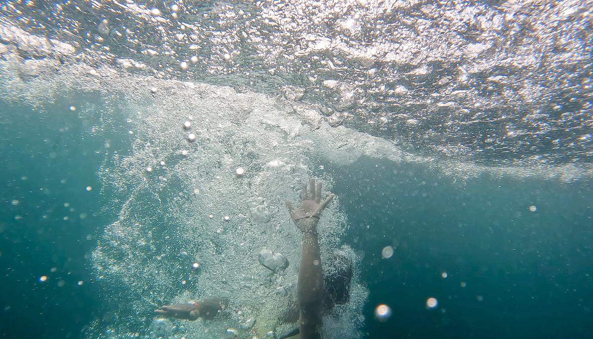 A person is submerged in water at Fantasy Lake Adventure Park on Monday, July 31, 2023, in Wake Forest, N.C.