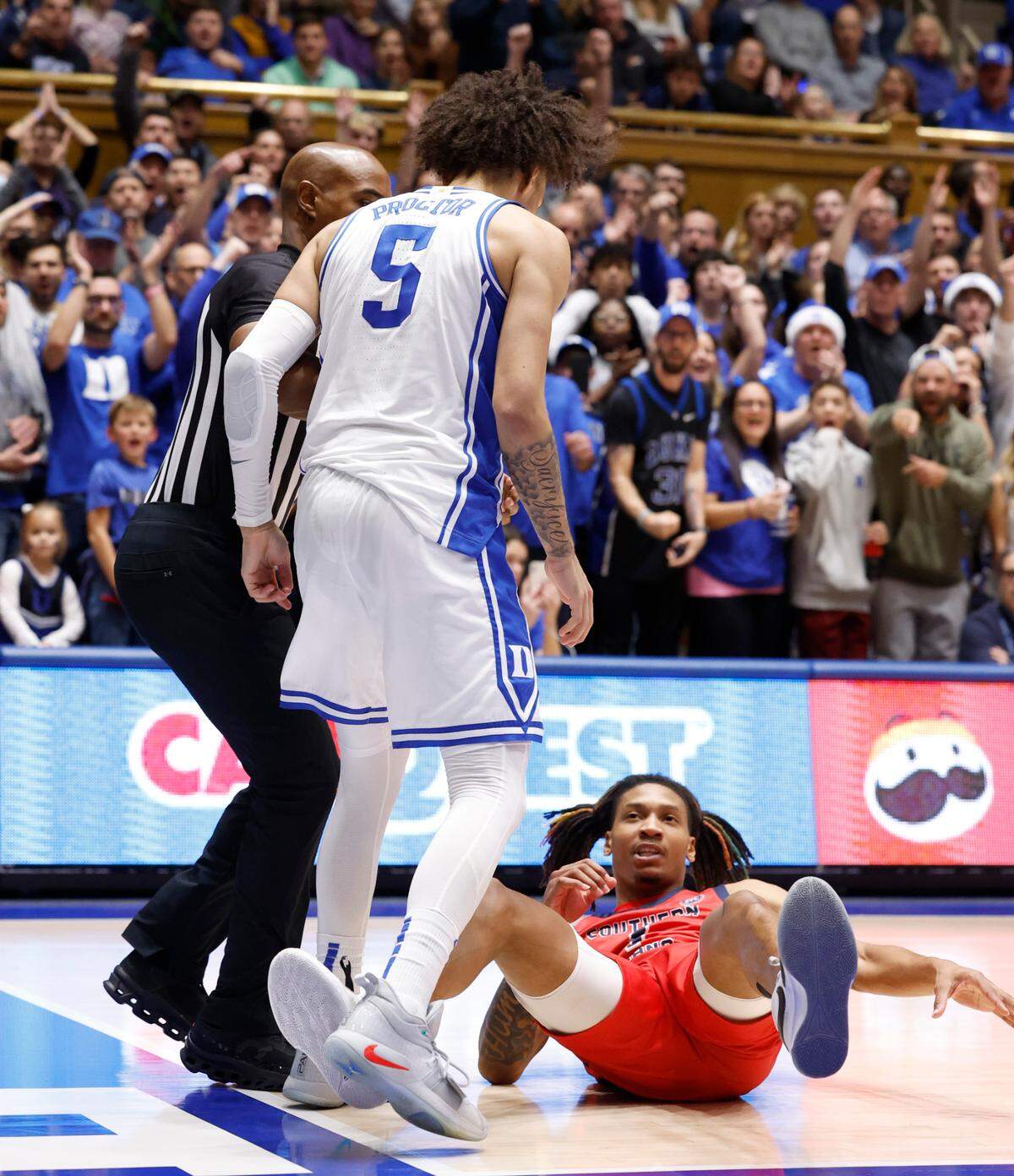 Duke’s Tyrese Proctor (5) stands over Southern Indiana’s Javius Moore (1) after Moore fouled him while Proctor was dunking the ball during the second half of Duke’s 80-62 victory over Southern Indiana at Cameron Indoor Stadium in Durham, N.C., Friday, Nov. 24, 2023.