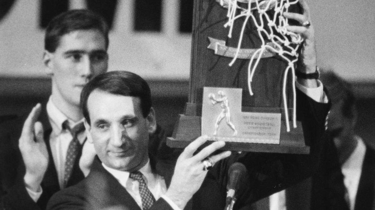Duke coach Mike Krzyzewski holds up the national Championship trophy to the crowd during a celebration in Cameron Indoor Stadium April 2, 1991. 