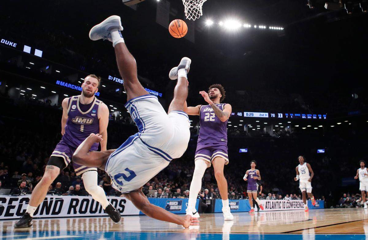 Duke’s Jaylen Blakes (2) goes down hard after being fouled by James Madison’s Noah Freidel (1) in the second half of Duke’s 93-55 victory over James Madison in the second round of the NCAA Tournament at the Barclays Center in Brooklyn, N.Y., Sunday, March 24, 2024.