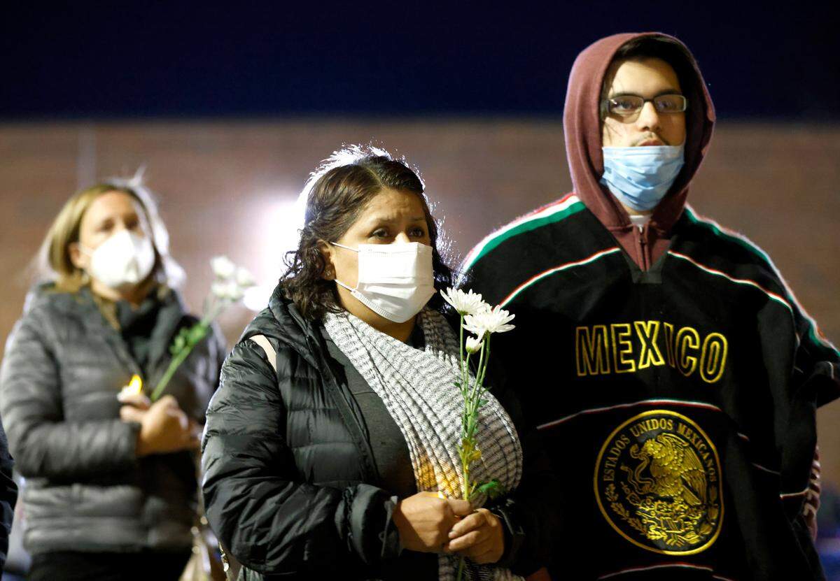 Attendees listen during a vigil for Daniel Turcios in Raleigh, N.C. January 14, 2022. Turcios was fatally shot by Raleigh police Tuesday afternoon after a crash on Interstate 440.
