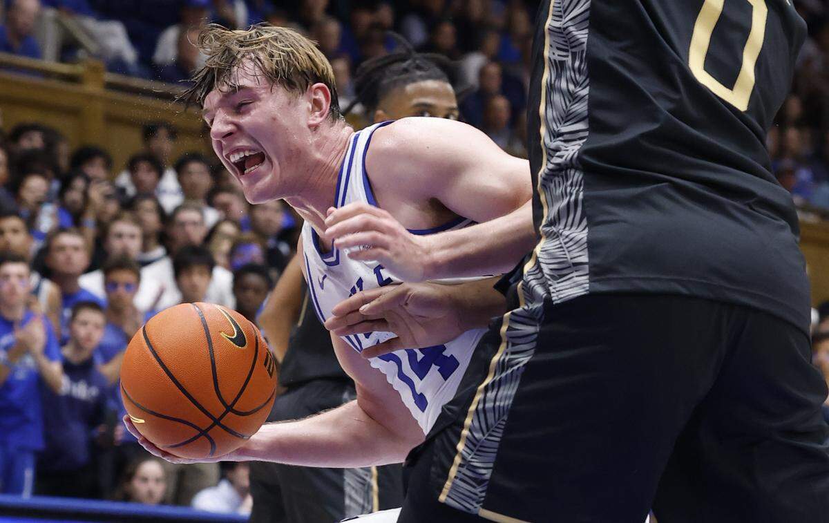 Duke’s Nikolas Khamenia (14) drives around UCF’s Jeremy Foumena (0) during the second half of Duke’s 96-71 exhibition victory over UCF at Cameron Indoor Stadium in Durham, N.C., Tuesday, Oct. 21, 2025.
