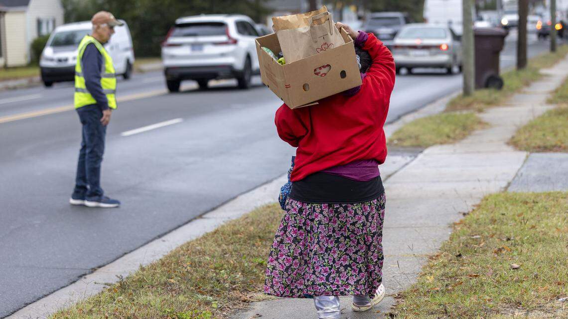 A recipient of the Emanuel Food Pantry at Durham Presbyterian Church, walks home with a box of groceries after visiting the weekly pantry on Roxboro Street on Wednesday, October 29, 2025 in Durham, N.C. A recipient of the Emanuel Food Pantry at Durham Presbyterian Church, walks home with a box of groceries after visiting the weekly pantry on Roxboro Street on Wednesday, October 29, 2025 in Durham, N.C.