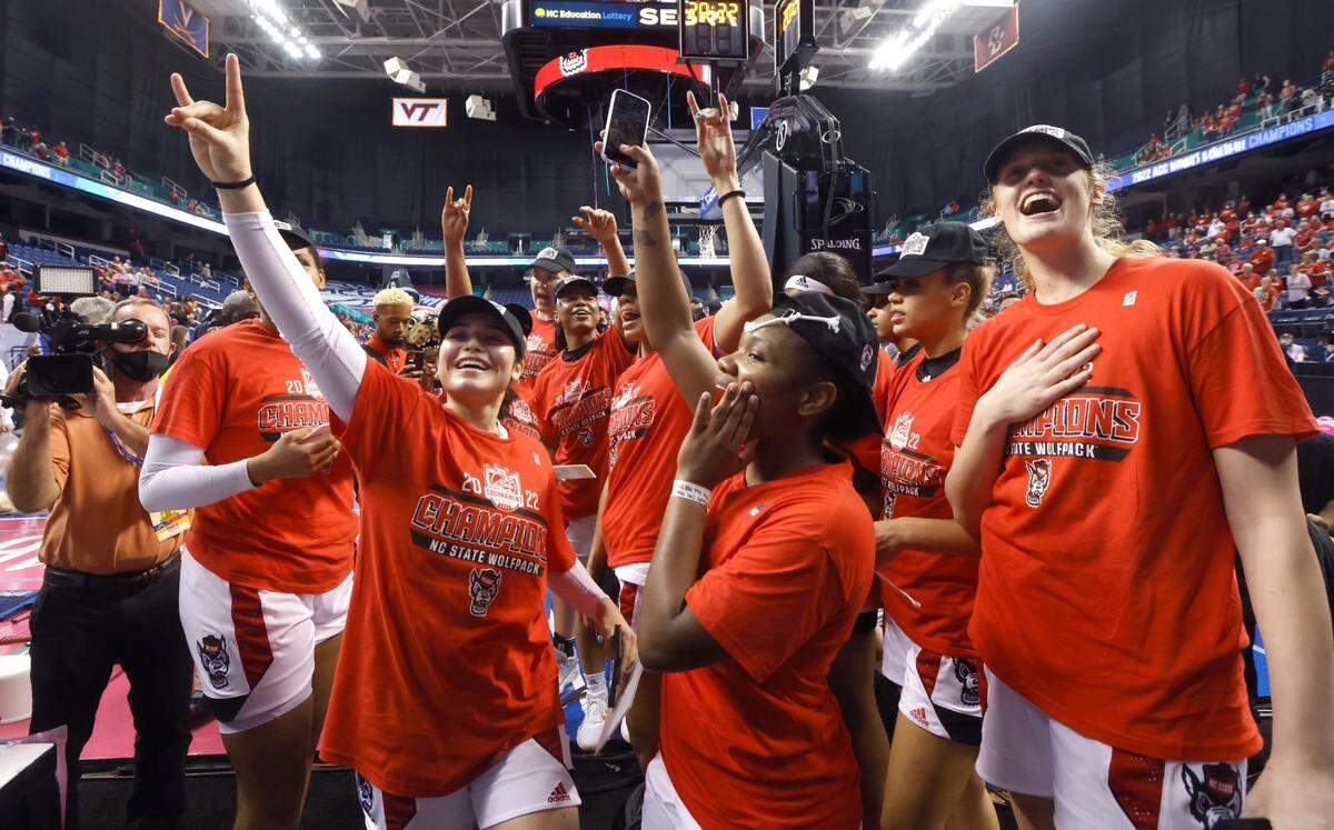 N.C. State players including Raina Perez, left, Diamond Johnson and Elissa Cunane acknowledge the fans after the Wolfpacks victory over Miami to win the ACC womens basketball tournament in Greensboro, N.C., Sunday, March 6, 2022.