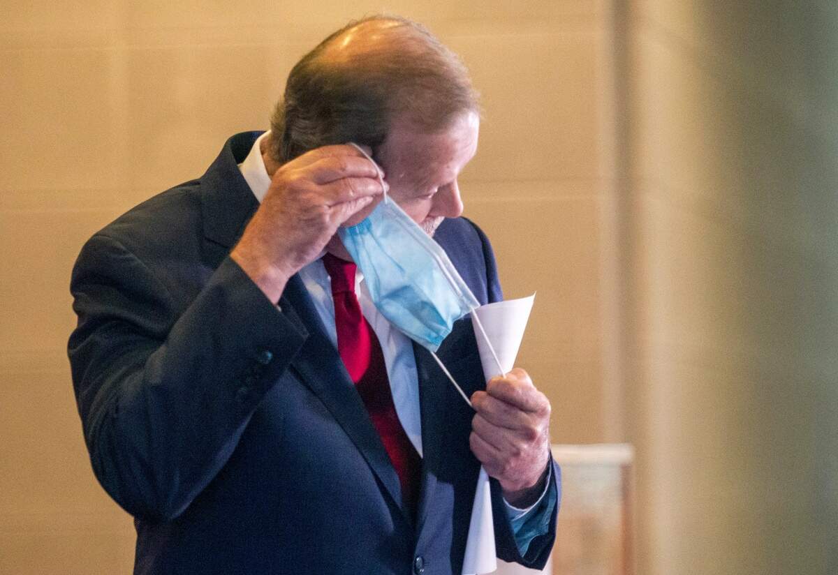 Phil Berger puts on a mask following a press conference at the Legislative Building Monday, May 18, 2020. ?Due to falling tax revenues spurred on by the coronavirus shutdown, state lawmakers expect to cut billions of dollars from the state budget.