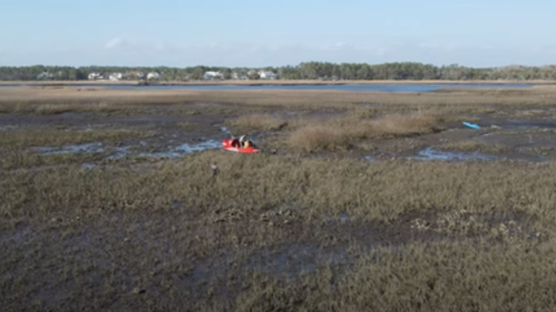 Three kayakers were found trapped in swamp mud on the North Carolina coast, including two who were stuck chest deep in mud, Oak Island Water Rescue says 