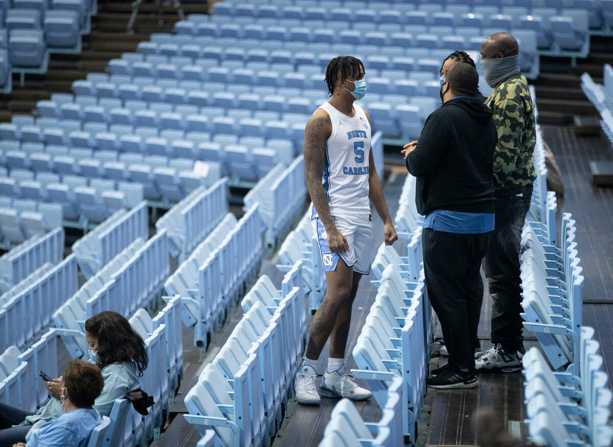 North Carolina’s Armando Bacot (5) talks with his family following the Tar Heels’ win over North Carolina Central University on Saturday, December 12, 2020 at the Smith Center in Chapel Hill, N.C.