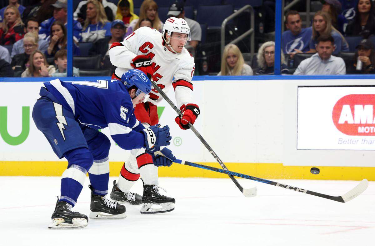 Sep 24, 2024; Tampa, Florida, USA; Carolina Hurricanes defenseman Skyler Brind’Amour (77) shoots the puck against the Tampa Bay Lightning during the second period at Amalie Arena. Mandatory Credit: Kim Klement Neitzel-Imagn Images