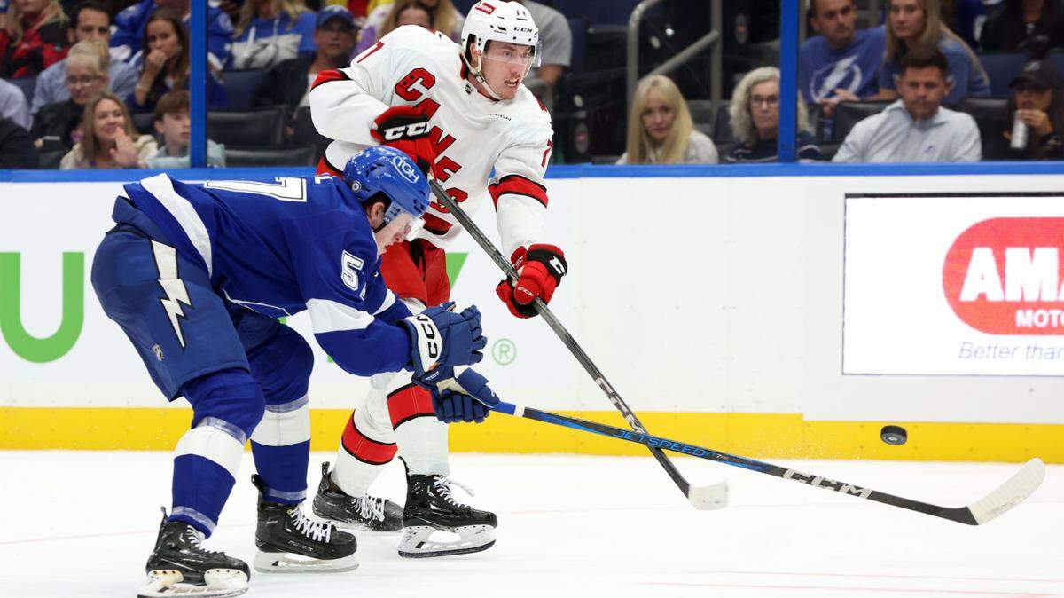 Sep 24, 2024; Tampa, Florida, USA; Carolina Hurricanes defenseman Skyler Brind’Amour (77) shoots the puck against the Tampa Bay Lightning during the second period at Amalie Arena. Mandatory Credit: Kim Klement Neitzel-Imagn Images