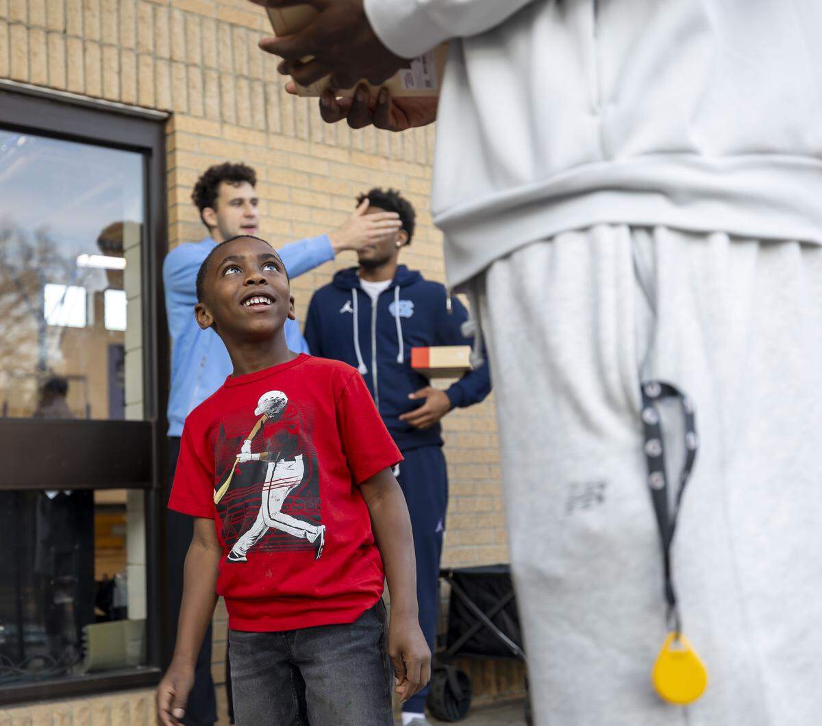 Seven-year-old Ayden Woodford looks up to North Carolina forward Caleb Wilson (8) during the Tar Heels’ visit to the Hargraves Community Center on Wednesday, January 7, 2026 in Chapel Hill, N.C.  Woodford bonded with Wilson when the two went on a Christmas shopping excursion last month.  