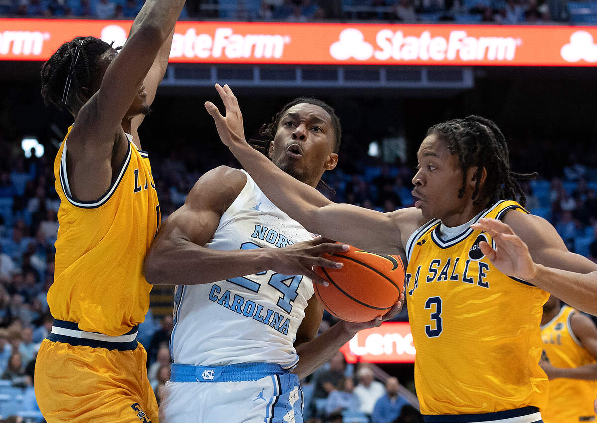 North Carolina’s Jae’Lyn Withers drives between La Salle’s Jahlil White and Eric Acker during the first half of the Tar Heels’ 93-67 win on Saturday, Dec. 14, 2024, at the Smith Center in Chapel Hill, N.C.