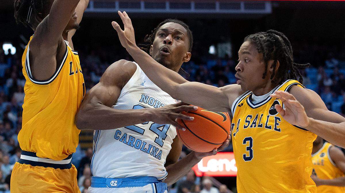 North Carolina’s Jae’Lyn Withers drives between La Salle’s Jahlil White and Eric Acker during the first half of the Tar Heels’ 93-67 win on Saturday, Dec. 14, 2024, at the Smith Center in Chapel Hill, N.C.