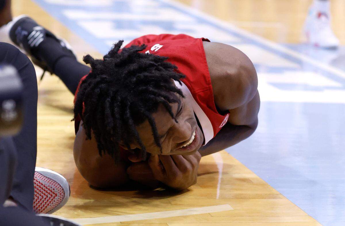N.C. State’s Terquavion Smith (0) is in pain after landing hard during the second half of N.C. State’s game against UNC at the Smith Center in Chapel Hill, N.C., Saturday, Jan. 21, 2023. Smith was stretchered off.