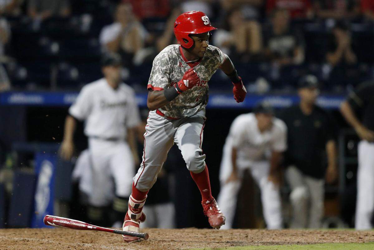 N.C. State’s Terrell Tatum (1) scrambles to first base to beat the throw in the ninth inning during N.C. State’s 6-5 victory over Wake Forest in the ACC Baseball Tournament at the Durham Bulls Athletic Park in Durham, N.C., Thursday, May 23, 2019.