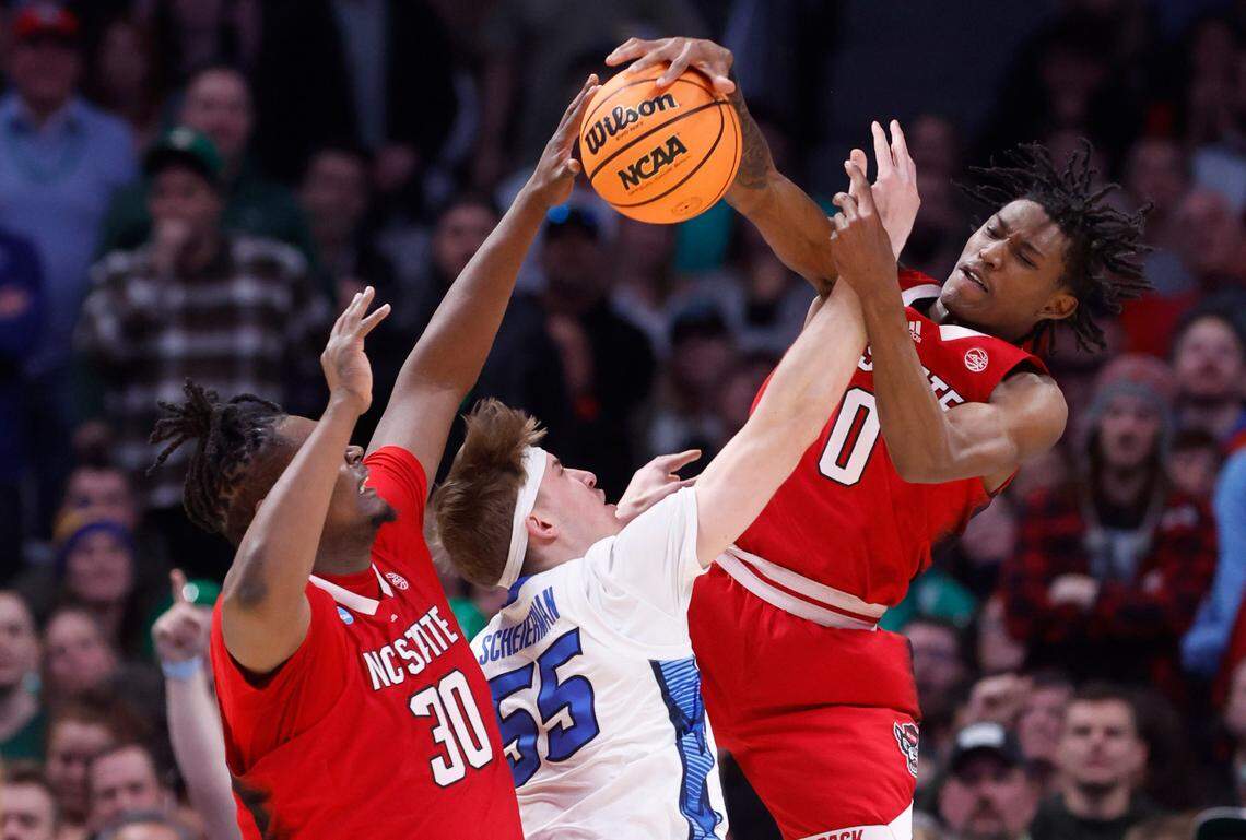 N.C. State’s Terquavion Smith (0) blocks the shot by Creighton’s Baylor Scheierman (55) as D.J. Burns Jr. (30) also defends during the second half of Creighton’s 72-63 victory over N.C. State in the first round of the NCAA Tournament at Ball Arena in Denver, Colo., Friday, March 17, 2023.
