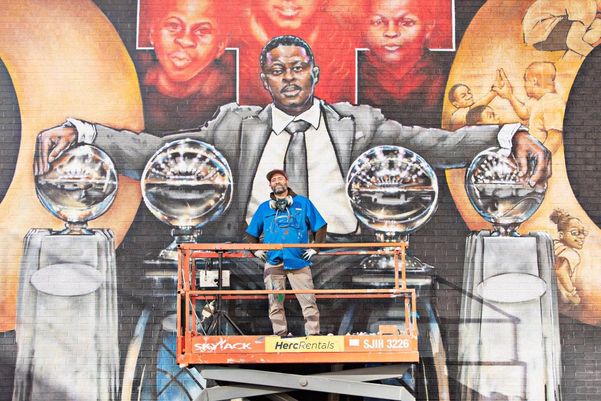Artist Sean Kernick takes a break from his mural to honor NCCU coach LaVelle Moton on Salibury St. in downtown Raleigh on Tuesday, Nov. 23. 2021.