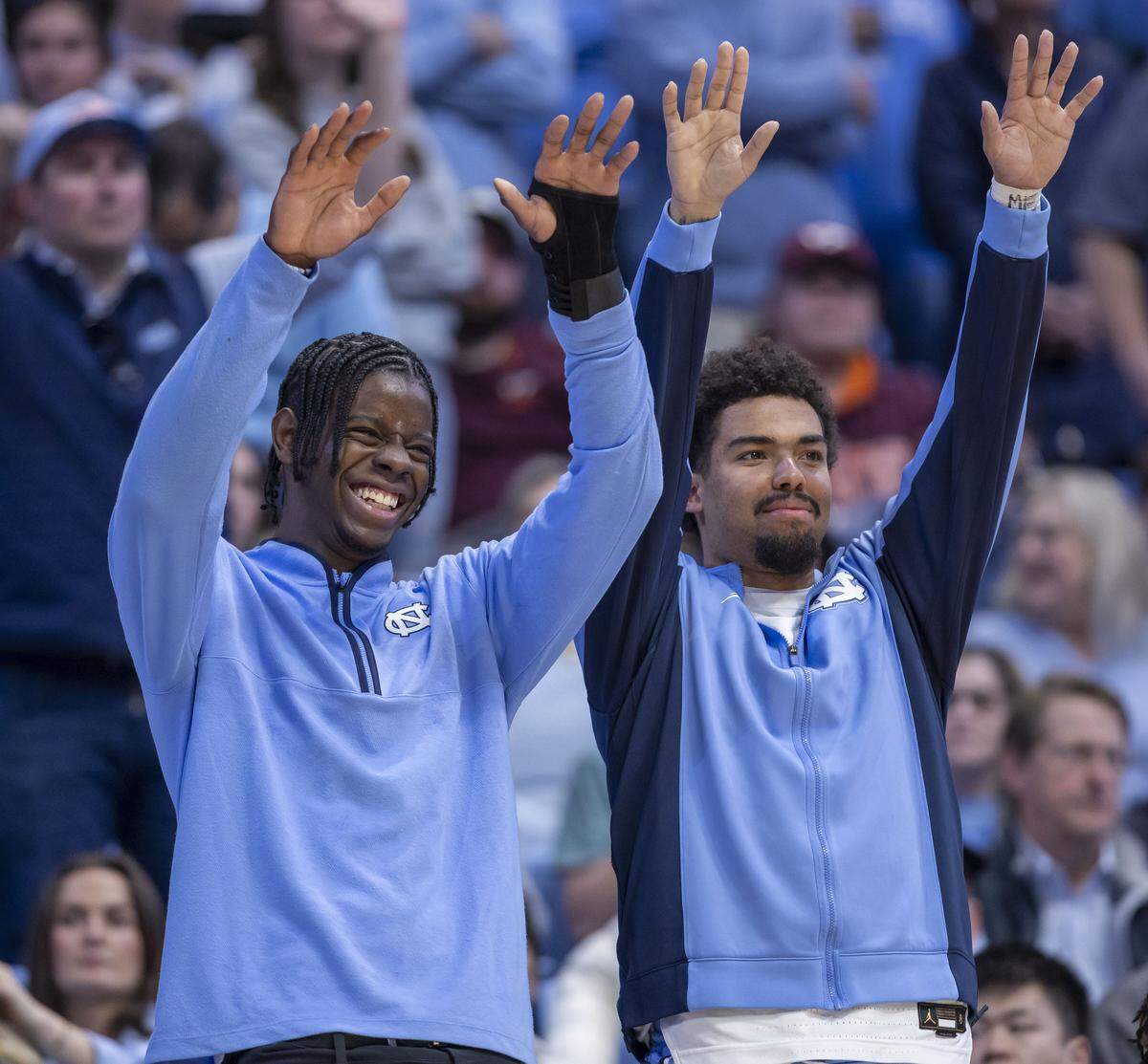 North Carolina forward Caleb Wilson, out recovering from a fractured left hand, stands with teammate Elijah Davis (6) to give support for teammate Henri Veesaar as he shoots free throws during the second half of the Tar Heels’ game against Virginia Tech on Saturday, February 28, 2026 at the Smith Center in Chapel Hill, N.C.