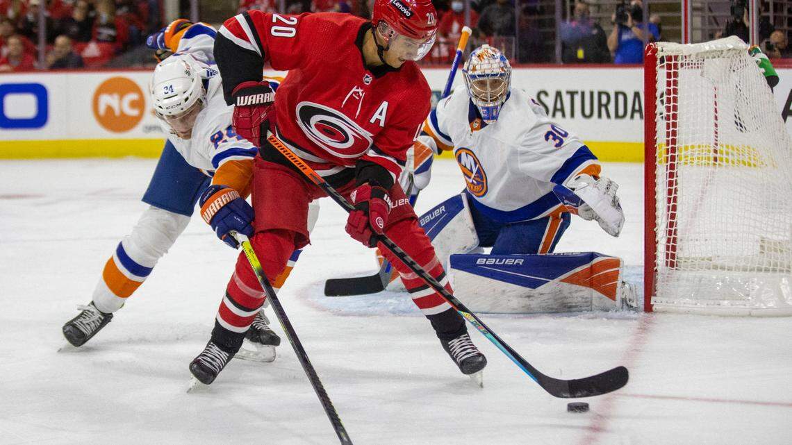 Carolina Hurricanes’ Sebastian Aho (20) works against New York Islanders’ Scott Mayfield (24) during the first period on Thursday, October 14, 2021 at PNC Arena in Raleigh, N.C.