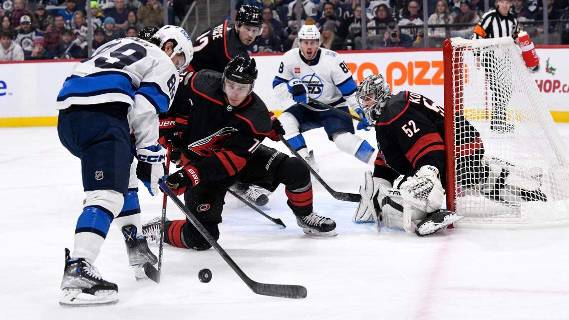 Carolina Hurricanes’ Brady Skjei defends as Winnipeg Jets’ Sam Gagner tires to get a shot on goaltender Pyotr Kochetkov during the second period of an NHL hockey game in Winnipeg, Manitoba, Monday, Nov. 21, 2022. (Fred Greenslade/The Canadian Press via AP)