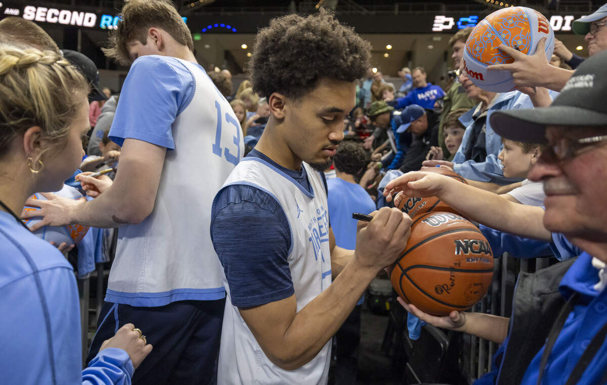 North Carolina players Henri Veesaar (13) and Seth Trimble (7) sign autographs for fans following the Tar Heels’ practice on Wednesday, March 18, 2026, at Bon Secours Arena in Greenville, S.C.
