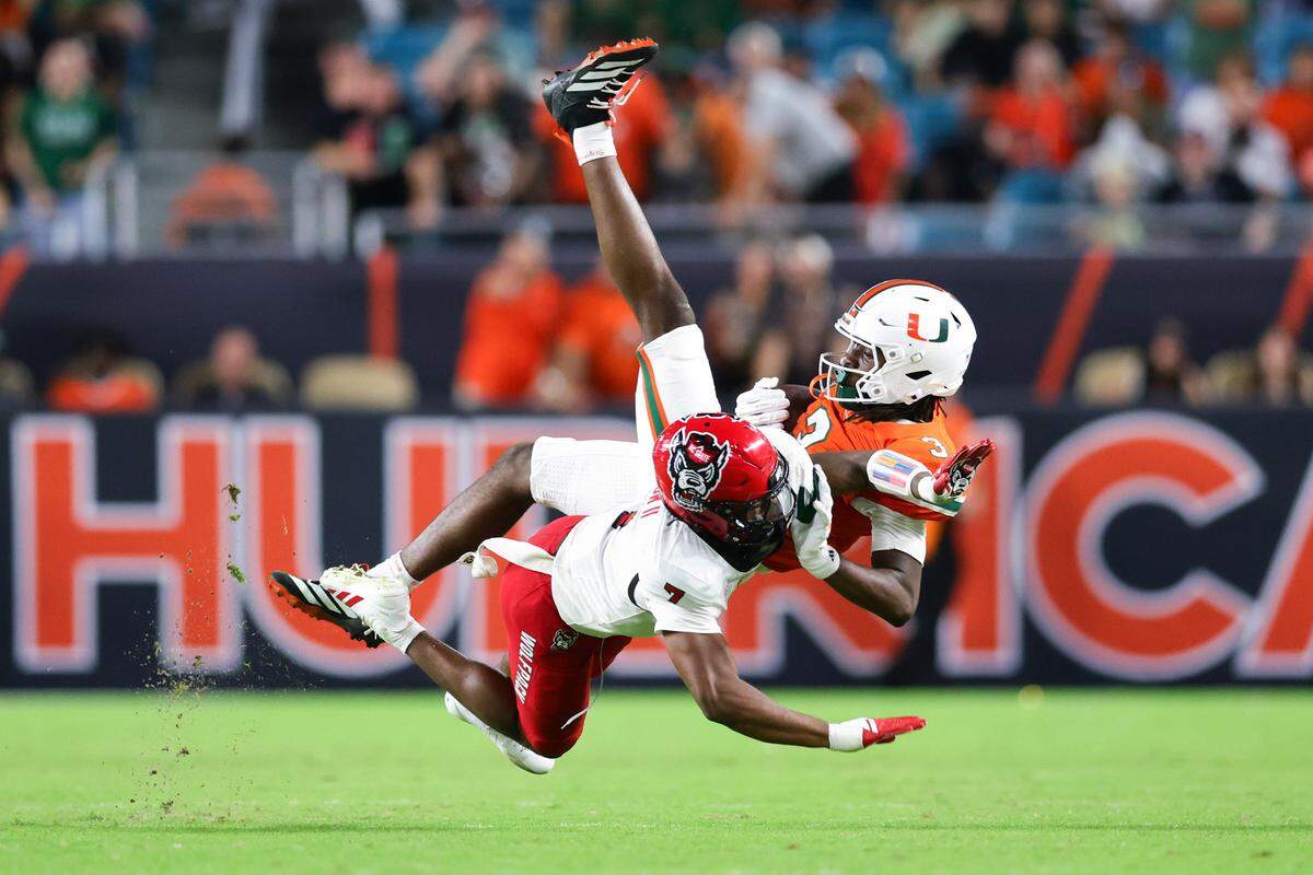 Miami’s Joshua Moore catches a pass against NC State’s Brian Nelson II during the fourth quarter of the game at Hard Rock Stadium on November 15, 2025 in Miami Gardens, Florida.