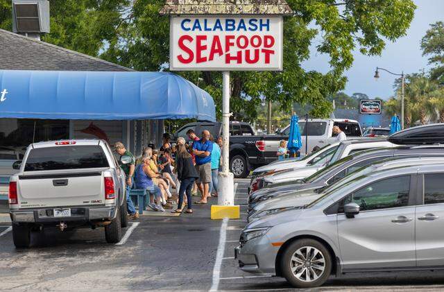 Visitors and vacationers line up to have dinner at the Calabash Seafood Hut on Thursday, June 27, 2024 in Calabash, N.C.