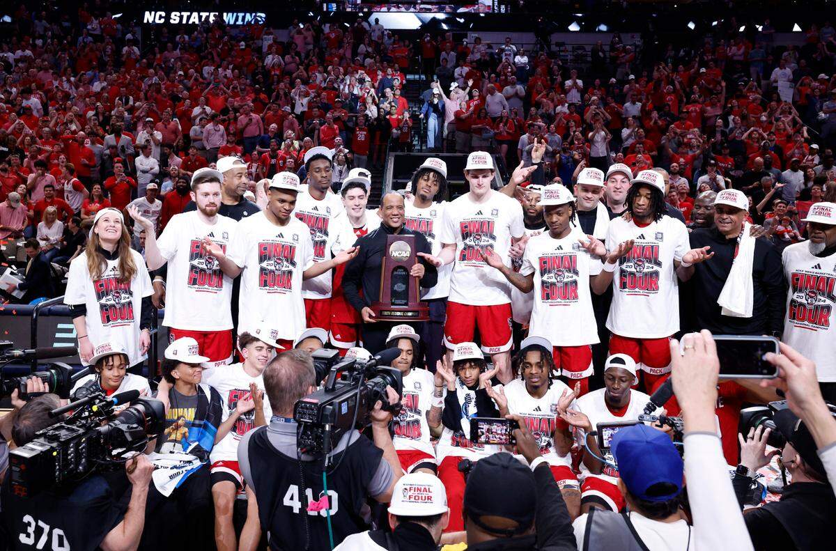 N.C. State holds up the South Regional championship trophy after N.C. State’s 76-64 victory over Duke in their NCAA Tournament Elite Eight matchup at the American Airlines Center in Dallas, Texas, Sunday, March 31, 2024.