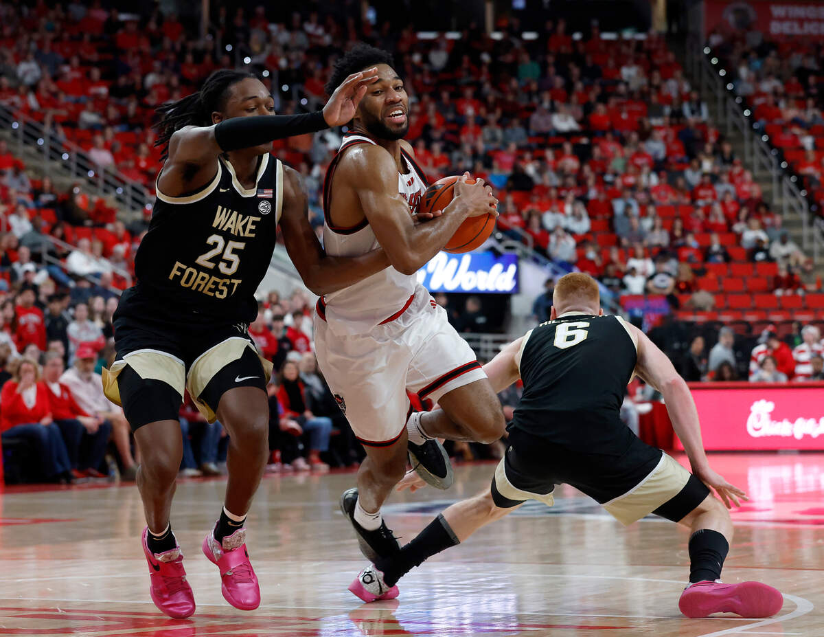 N.C. State’s Dontrez Styles drives past Wake Forest’s Tre’Von Spillers and Cameron Hildreth during the second half of the Wolfpack’s 85-73 win on Saturday, Feb. 22, 2025, at Lenovo Center in Raleigh, N.C.