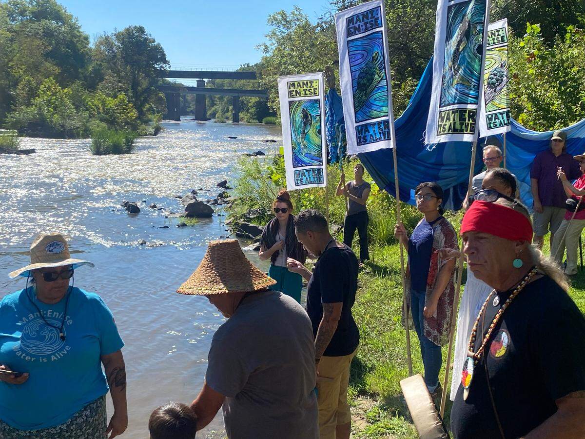 Activists with the Saponi and Lummi tribes join environmental activists for a water blessing ceremony at the Haw River.