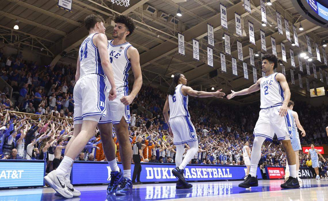 Duke’s Cameron Boozer (12) congratulates Nikolas Khamenia (14) during Duke’s 76-61 victory over UNC at Cameron Indoor Stadium in Durham, N.C., Saturday, March 7, 2026.