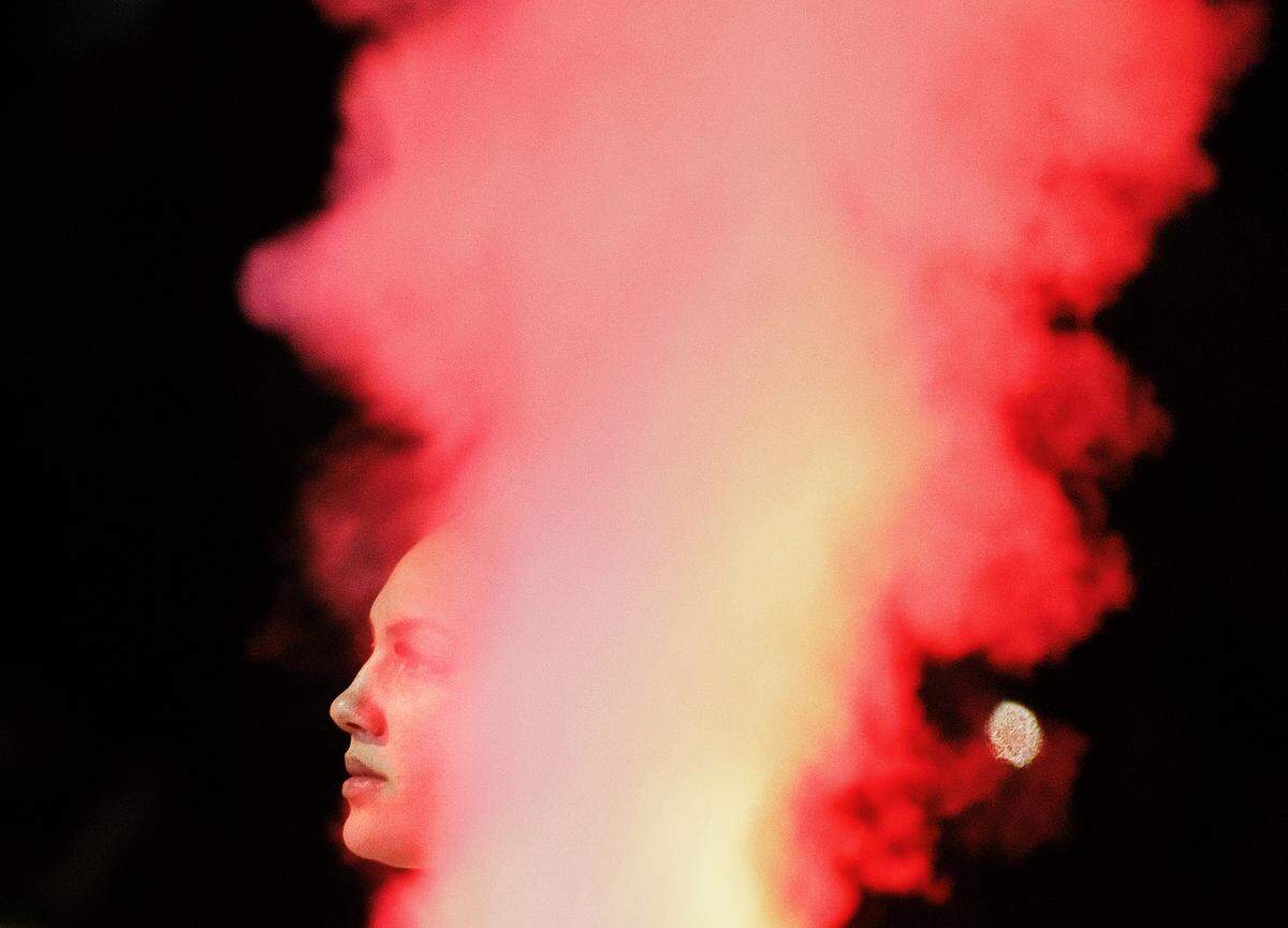 Plumes of smoke surround N.C. State’s Mimi Collins during pregame introductions prior to the Wolfpack’s game against Florida State on Thursday, Jan. 4, 2023, at Reynolds Coliseum in Raleigh, N.C.
