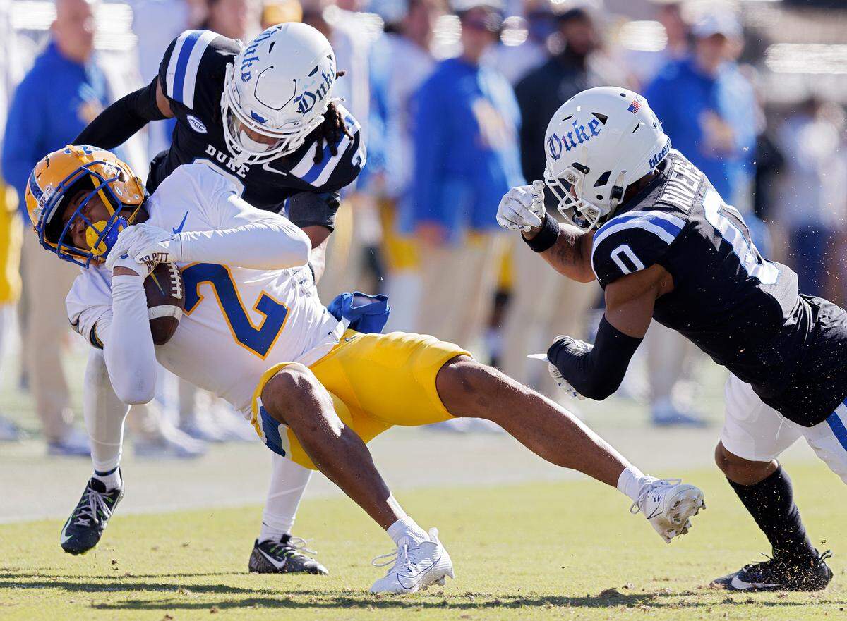 Pittsburgh’s Kenny Johnson is tackled by Duke’s Brandon Johnson and Chandler Rivers during the first half of the Blue Devils’ 30-19 win on Saturday, Nov. 25, 2023, at Wallace Wade Stadium in Durham, N.C.