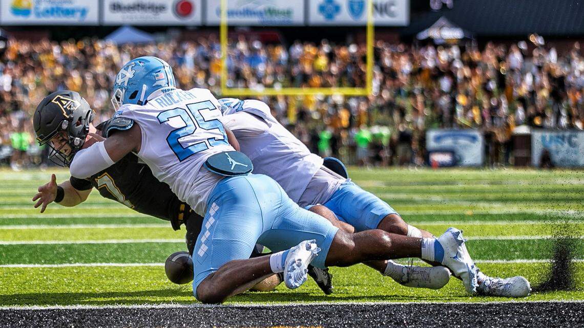 North Carolinaís Noah Taylor (7) and Caiman Rucker (25) stop Appalachian State quarterback Chase Brice at the goal line with :09 second to play, preventing a two-point conversion and securing North Carolinaís 63-61 victory on Saturday, September 3, 2022 at Kidd Brewer Stadium in Boone, N.C.