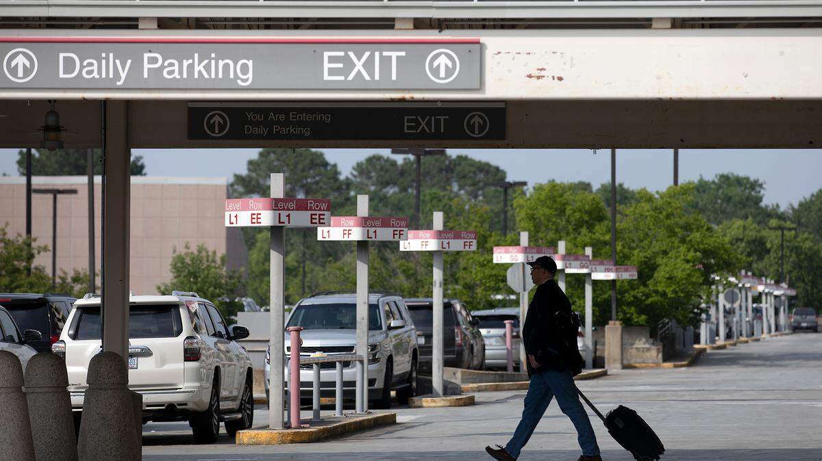 A person walks through a parking area at Raleigh-Durham International Airport on Monday, May 22, 2023.
