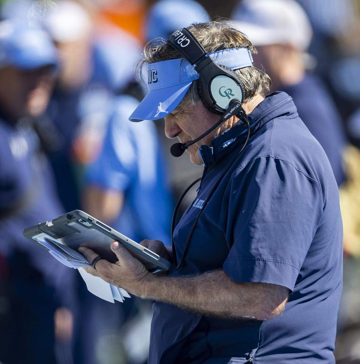North Carolina coach Bill Belichick studies his tablet in the fourth quarter, down 35-3 against Clemson on Saturday, October 4, 2025 at Kenan Stadium in Chapel Hill, N.C.