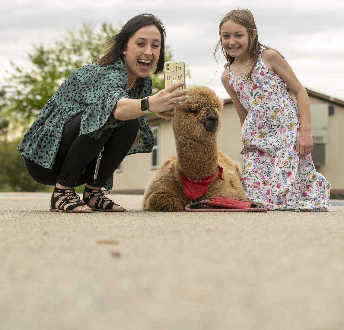Ballentine Elementary School teacher Monica Rehl takes a selfie with fourth grader Juliette McInnis and Pumpkin the visiting Alpaca on Tuesday, April 12, 2022 in Fuquay-Varina, N.C.