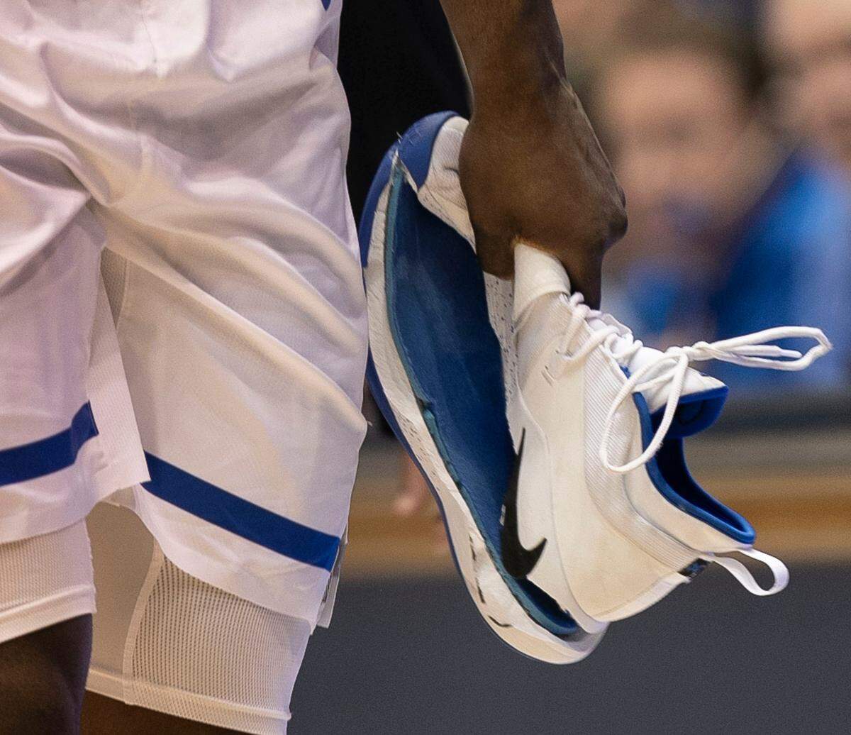 Duke’s Zion Williamson (1) leaves the court with his damaged shoe after taking a fall during the opening moments of the Blue Devils’ game against North Carolina on Wednesday, February 20, 2019 at Cameron Indoor Stadium in Durham, N.C.