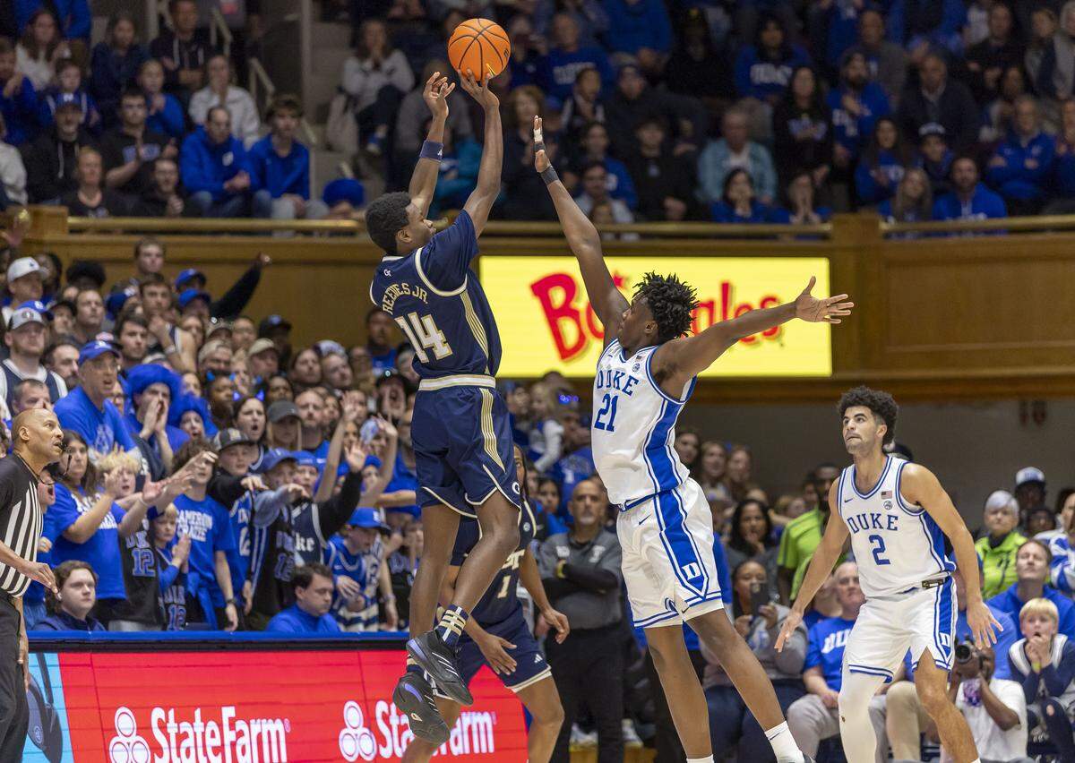 Georgia Tech forward Kowacie Reeves Jr. (14) launches a three-point shot over Duke center Patrick Ngongba II (21) in the second half  on Wednesday, December 31, 2025 at Cameron Indoor Stadium in Durham, N.C. Reeves Jr. lead the Yellowjackets with 23 points. 