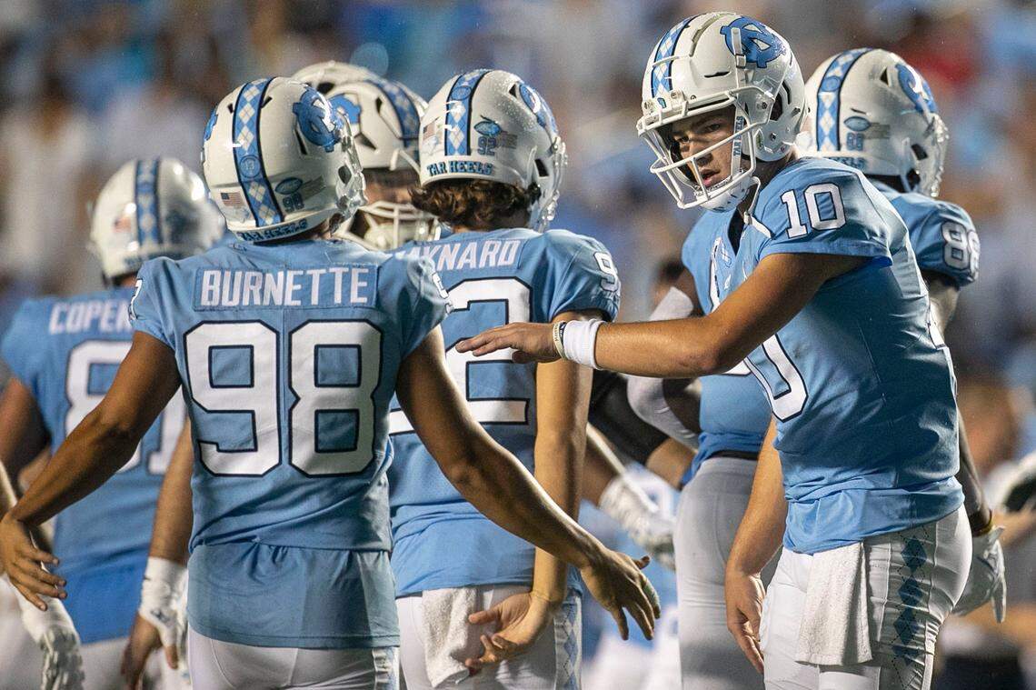 North Carolina quarterback Drake Maye (10) congratulates the kicking unit after an extra point in the first quarter against Florida A&M on Saturday, August 27, 2022 at Kenan Stadium in Chapel Hill, N.C.