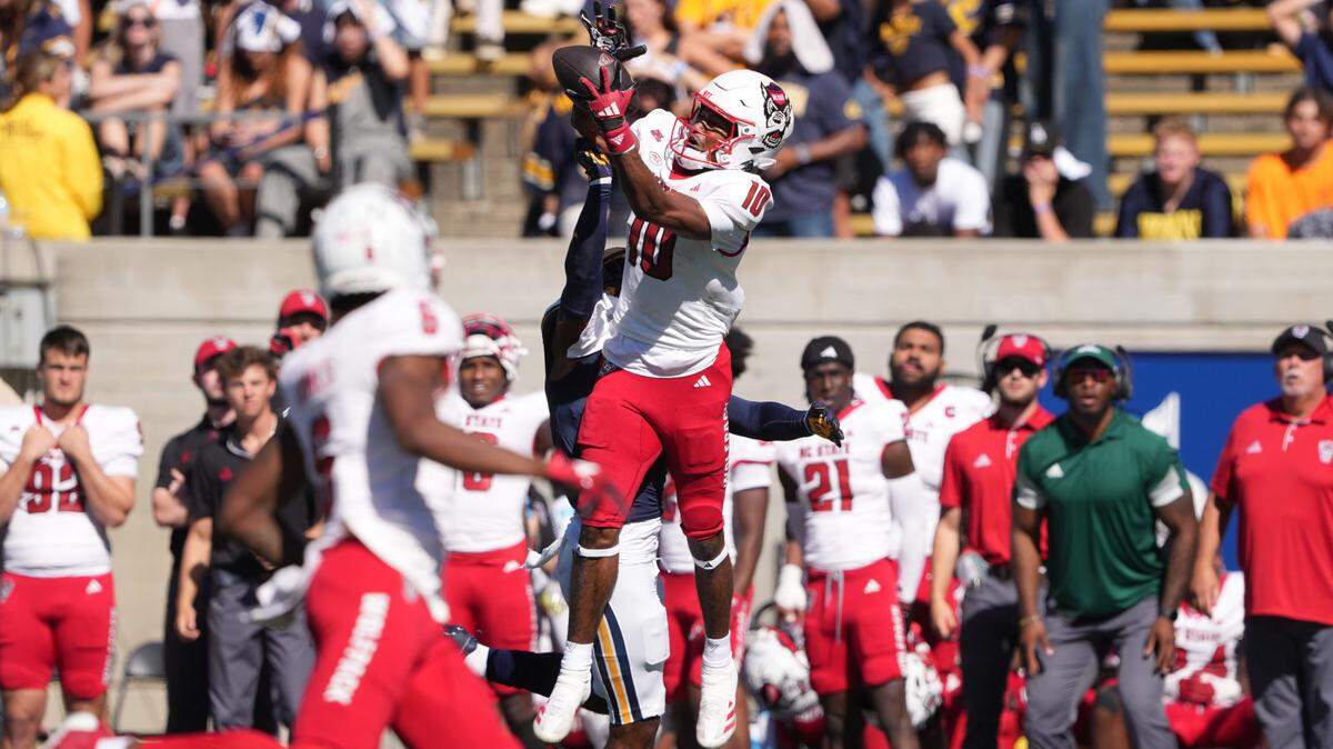Oct 19, 2024; Berkeley, California, USA; North Carolina State Wolfpack wide receiver Kevin Concepcion (10) catches a pass against California Golden Bears defensive back Craig Woodson (center left) during the second quarter at California Memorial Stadium. Mandatory Credit: Darren Yamashita-Imagn Images