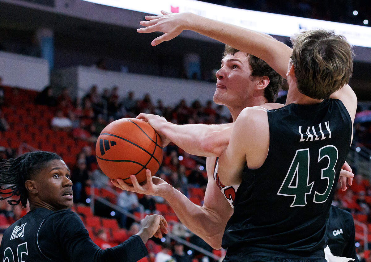 N.C. State’s Ben Middlebrooks powers past William & Mary’s Finn Lally during the second half of the Wolfpack’s 84-61 win at Lenovo Center on Friday, Nov. 22, 2024, in Raleigh, N.C.