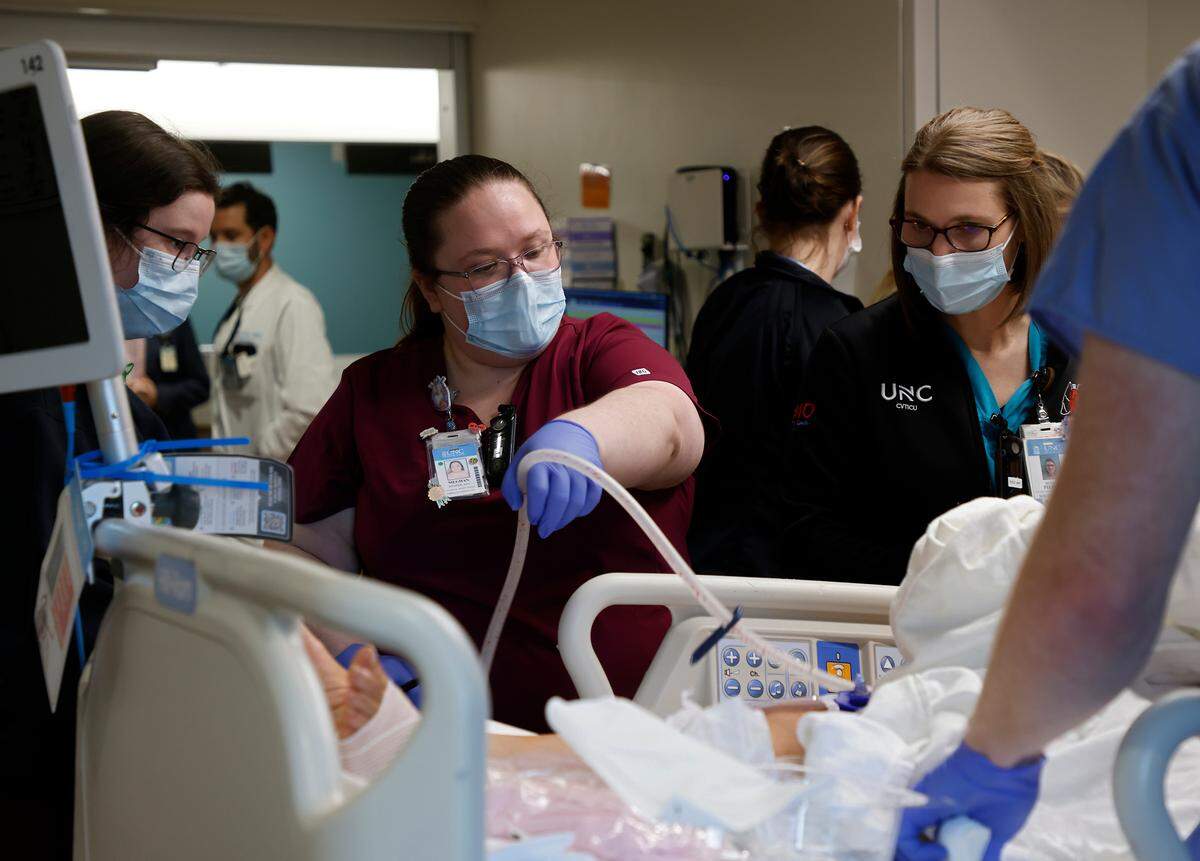 Clinical support technician Meghan Keister, center, works with a patient on the Cardiovascular & Thoracic Intensive Care Unit at UNC Hospital on Thursday, Sept. 29, 2022, in Chapel Hill, N.C.