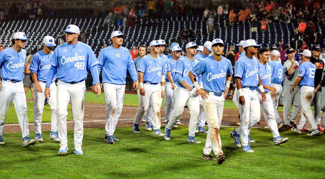North Carolina players return to the dugout following the Tar Heels' loss to Oregon State in the NCAA College World Series baseball elimination game Wednesday, June 20, 2018 in Omaha, Neb..