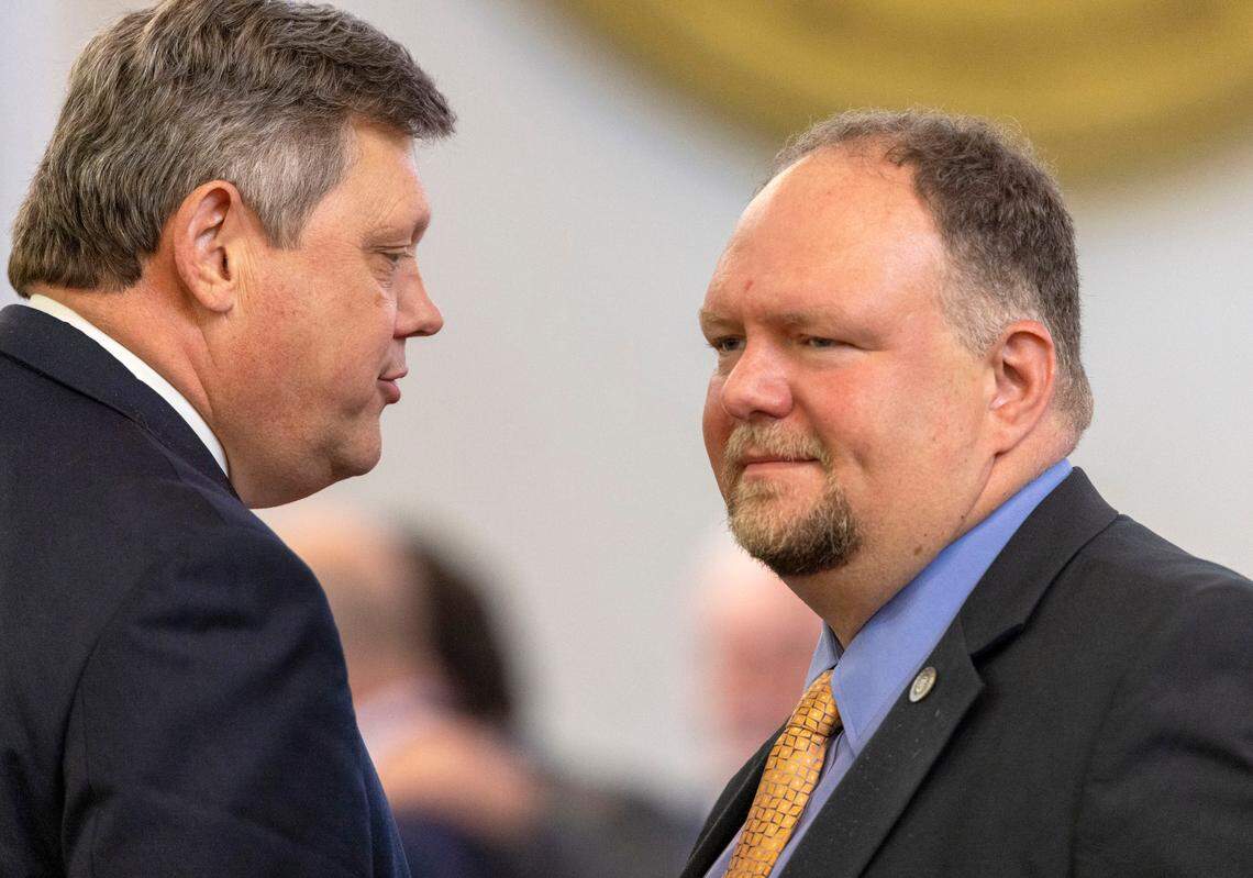 Democratic Senator Mike Woodard, left, talks with Republican Senator Ralph Hise following the passage of Medicaid expansion by the Senate on Wednesday, June 1, 2022 at the General Assembly in Raleigh, N.
