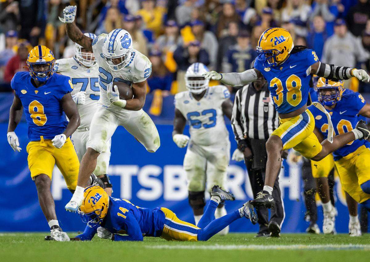 North Carolina running back Omarion Hampton (28) hurdles over Pitt’s Marquis Williams (14) for a 26-yard run the third quarter on Saturday, September 23, 2023 at Acrisure Stadium in Pittsburgh, Pa.