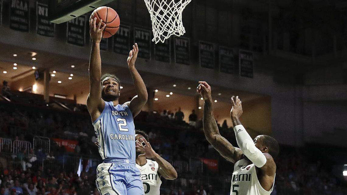 North Carolina Tar Heels guard Coby White shoots and scores against Miami Hurricanes guard Chris Lykes during the first half of an NCAA college basketball game on Saturday, Jan. 19, 2019, in Coral Gables, Fla.