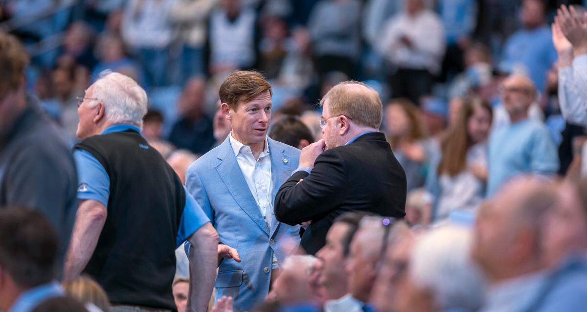 University of North Carolina Chancellor Lee Roberts talks with University of North Carolina President Peter Hans during a time-out at the North Carolina vs Boston College men’s basketball game on Saturday, January 25, 2025 at the Smith Center in Chapel Hill, N.C.